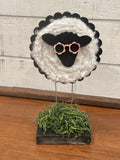 DIY lamb project features laser-cut elements that combine with a chunky wood base and wirey legs for a primitive style decor that exudes whimsy and joy.